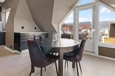 a dining room with a table and some chairs at Penthouse apartment in Bergen in Bergen