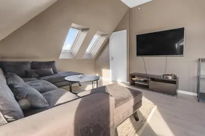 a living room with a couch and a flat screen tv at Penthouse apartment in Bergen in Bergen