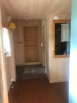 a small hallway with a door in a room at Gamlestogo, Rønlund Hyttepark in Ron