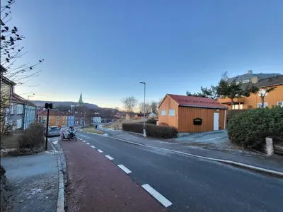an empty street with a motorcycle parked on the side of the road at Mercury House, Cathedral View ! Free Parking ! in Trondheim