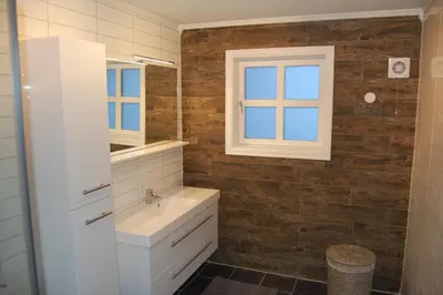 a bathroom with a sink and a window at Feriehus nede ved sjøen inntil 6 pers in Vestnes