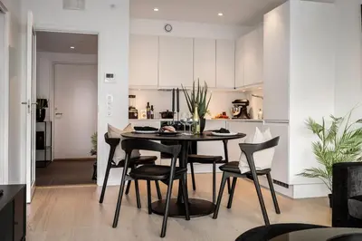 a kitchen and dining room with a table and chairs at New penthouse apartment with sea view in Bergen centrum in Bergen