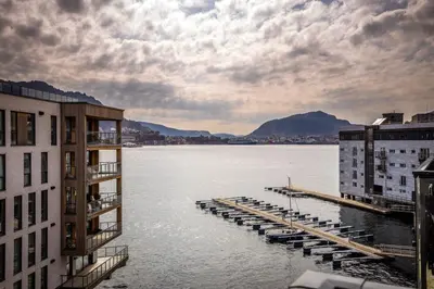 a large body of water with buildings and a dock at New penthouse apartment with sea view in Bergen centrum in Bergen