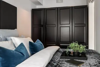 a living room with a couch and blue pillows at New penthouse apartment with sea view in Bergen centrum in Bergen