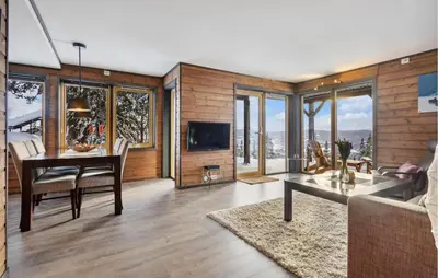 a living room with a table and a couch at Beautiful Apartment In Meråker in Meråker