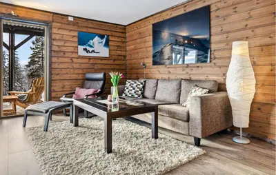 a living room with a couch and a table at Beautiful Apartment In Meråker in Meråker
