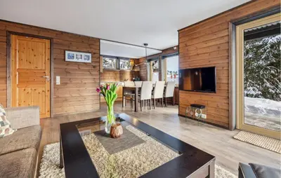 a living room with a couch and a table and a tv at Beautiful Apartment In Meråker in Meråker