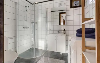 a bathroom with a shower and a toilet and a sink at Beautiful Apartment In Meråker in Meråker