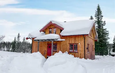 a wooden cabin with snow on the roof at 2 Bedroom Nice Home In Aust- Torpa in Aust-Torpa