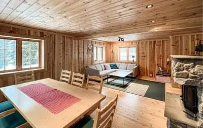 a living room with a table and a couch at 2 Bedroom Nice Home In Aust- Torpa in Aust-Torpa