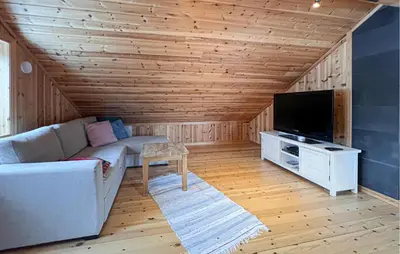 a living room with a couch and a flat screen tv at 2 Bedroom Nice Home In Aust- Torpa in Aust-Torpa