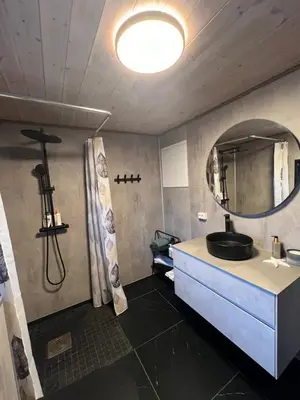 a bathroom with a sink and a mirror at Turer, avslapping, jakt, fiske, utsikt in Etnesjøen