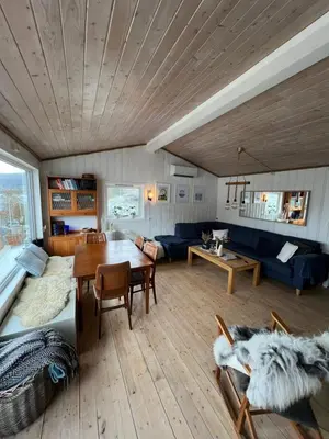 a living room with a table and a couch at Turer, avslapping, jakt, fiske, utsikt in Etnesjøen