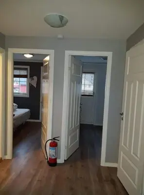 a room with two doors and a fire extinguisher at Rorbu i Austevoll med 3 soverom og mulighet for båtleie in Kolbeinsvik
