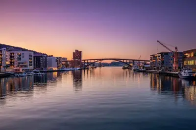 a view of a river with a bridge and buildings at Modern apartment in the heart of Bergen in Bergen
