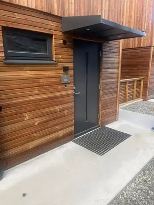 a front door of a building with a black door at Hyt leilighet med 2 soverom in Bjorli