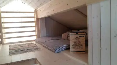 a small room with a bed in a attic at Sveheim - cabin with an amazing view in Flå