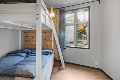 a bedroom with a bunk bed and a window at Elegant Urban Apartment in Bergen