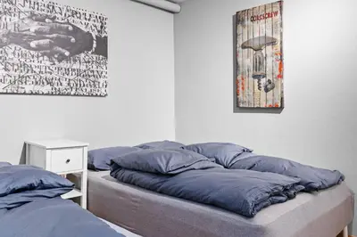 a bed with blue pillows on it in a room at Peaceful Urban Residence in Bergen