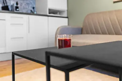 a drink on a black table in a living room at Peaceful Urban Residence in Bergen