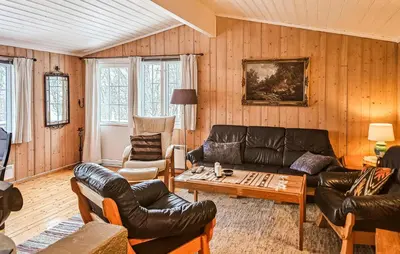 a living room with a leather couch and a table at 3 Bedroom Stunning Home In Uvdal in Uvdal