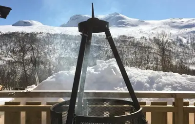 a trash can with a snow covered mountain in the background at 3 Bedroom Stunning Home In Uvdal in Uvdal