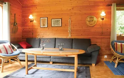 a living room with a couch and a table at Holiday Home Sandeid Ilsvåg in Sandeid