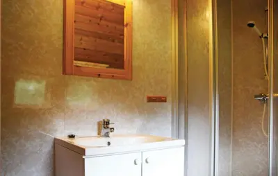 a bathroom with a sink and a shower at Holiday Home Sandeid Ilsvåg in Sandeid