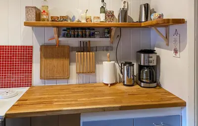 a kitchen with a wooden counter top with a coffee maker at 2 Bedroom Lovely Home In Innfjorden in Innfjorden