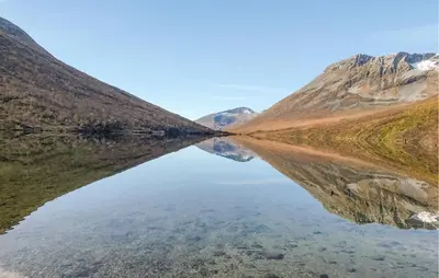 a reflection of a mountain in a body of water at 2 Bedroom Lovely Home In Innfjorden in Innfjorden