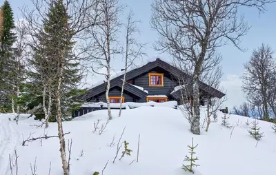 a log cabin in the snow with trees at 4 Bedroom Pet Friendly Home In Tydal in Tydal