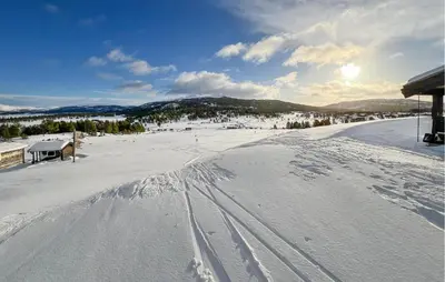 a snow covered slope with tracks in the snow at Gorgeous Apartment In Kvam With Sauna in Kvam