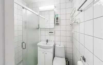 a white bathroom with a toilet and a sink at Gorgeous Apartment In Kvam With Sauna in Kvam