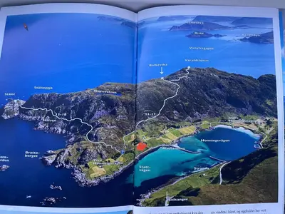 an open book with a map of the island at Honey bay cottage in Stadlandet