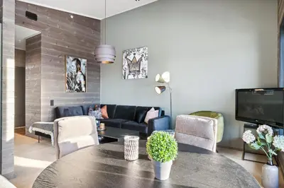 a living room with a table and a couch at Riddergaardens utsikt in Beitostøl