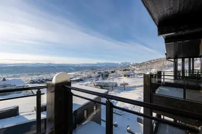a balcony with a view of a town in the snow at Riddergaardens utsikt in Beitostøl