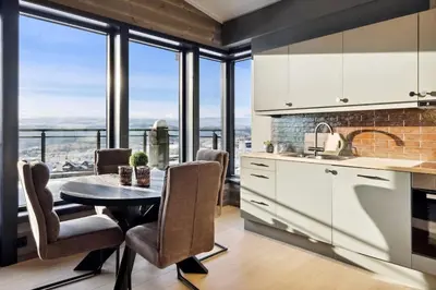 a kitchen with a table and chairs with a view at Riddergaardens utsikt in Beitostøl