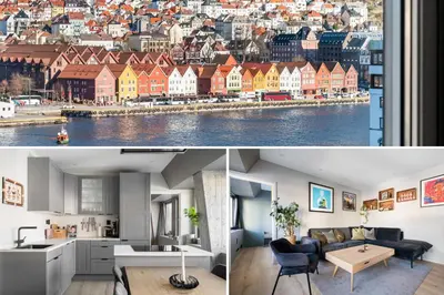 a living room and kitchen with a view of a city at Nordnes - Amazing view of Bryggen! in Bergen