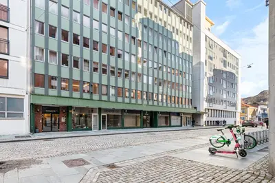 a bike parked in front of a building at Nordnes - Amazing view of Bryggen! in Bergen
