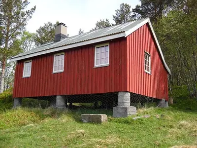 a red house on top of a hill at Orset setra - back to basic cabin - with amazing view in Torvikbukt