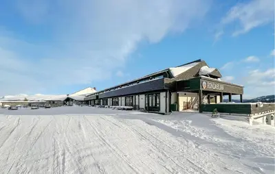 a building in the snow with a snow covered ground at Gorgeous Apartment In Kvam With Kitchen in Kvam