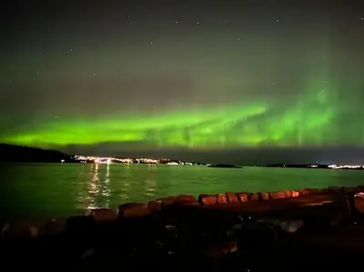 an aurora in the sky over a body of water at Brattøya sjøstuer in Kristiansund