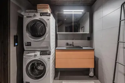 a laundry room with a washer and dryer next to a sink at Kikut Alpin Lodge 2302 in Geilo