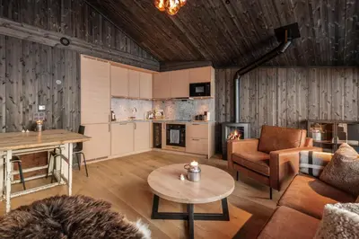 a living room with a couch and a table at Kikut Alpin Lodge 2302 in Geilo