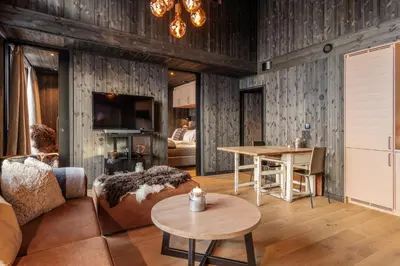 a living room with a couch and a table at Kikut Alpin Lodge 2302 in Geilo