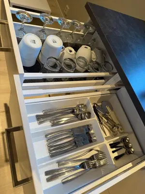 a drawer filled with silver utensils in a kitchen at Cozy basement apartment in Orkanger in Orkanger