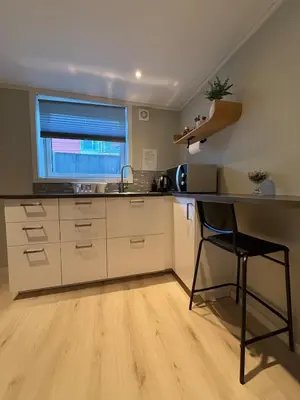 a kitchen with a counter and a sink and a window at Cozy basement apartment in Orkanger in Orkanger