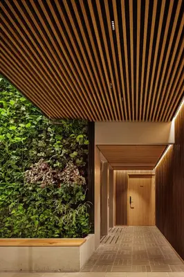 a hallway with a large green wall at Skostredet Hotel & Spa in Bergen