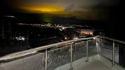 a view of a city in the snow at night at Trilodge - Unique cabin with high standard, views, ski in & out, attractive location in Meråker