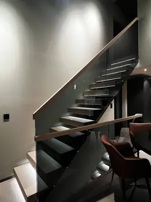 a staircase in a room with two chairs at Trilodge - Unique cabin with high standard, views, ski in & out, attractive location in Meråker